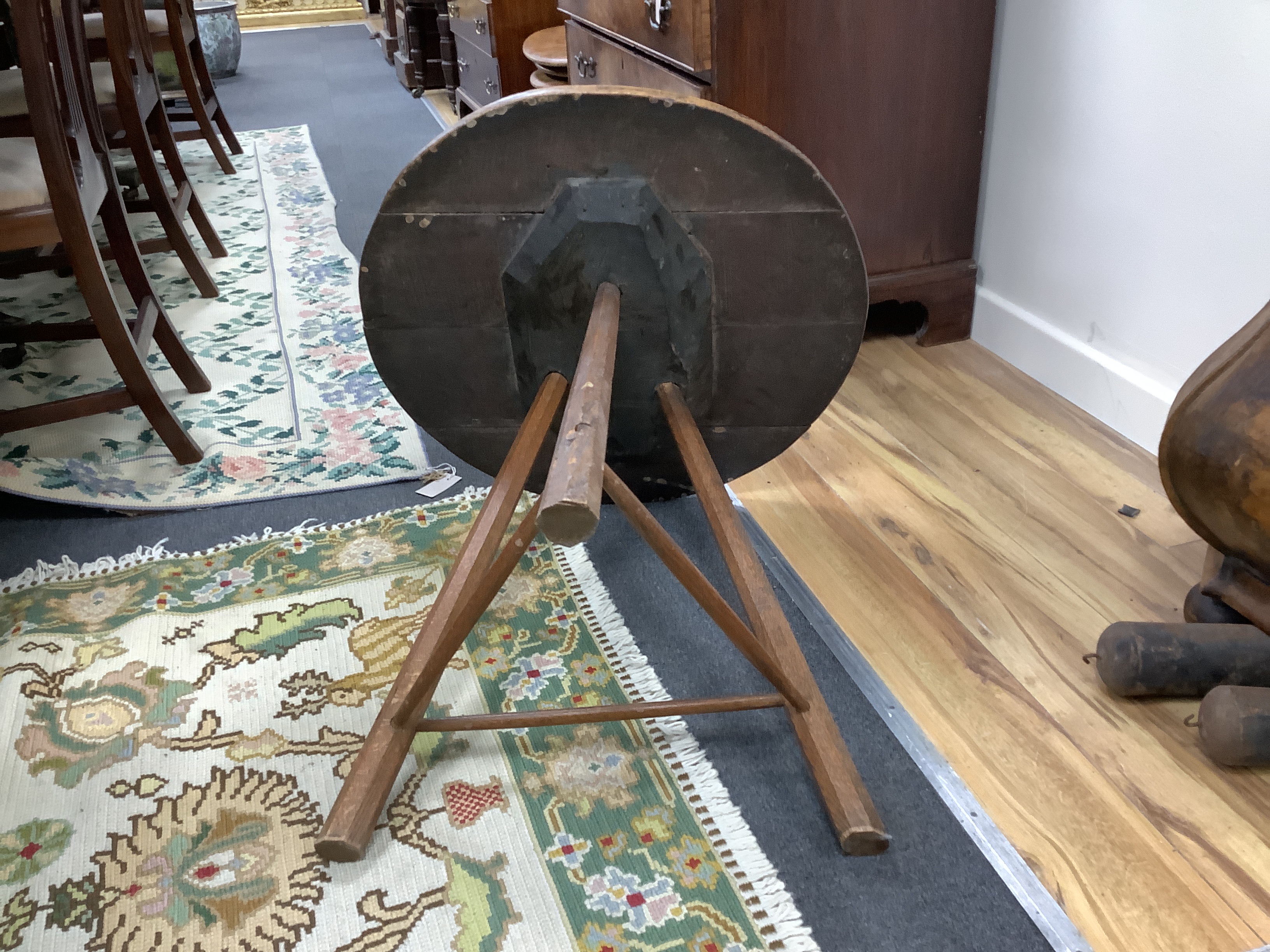 A circular oak cricket table, diameter 65cm, height 69cm
